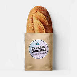 A loaf of bread inside a brown paper bag featuring a bakery logo sticker with a pastel wavy design, placed against a bright blue background.