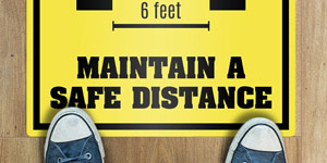 Feet stepping on a large sticker applied to the floor. 