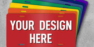 An array of colorful license plates with text that reads Your Design Here fanned out on top of a concrete surface. 