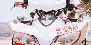 A white ATV or Snowmobile with red registration numbers applied above the headlights.